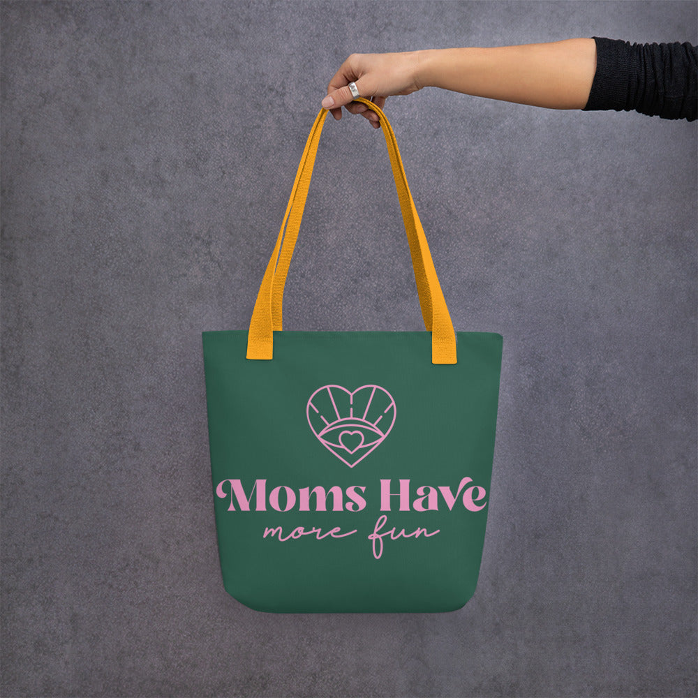 A trendy tote for moms, displaying the "Moms Have More Fun" design in green and pink, with a yellow handle, combining fashion and functionality