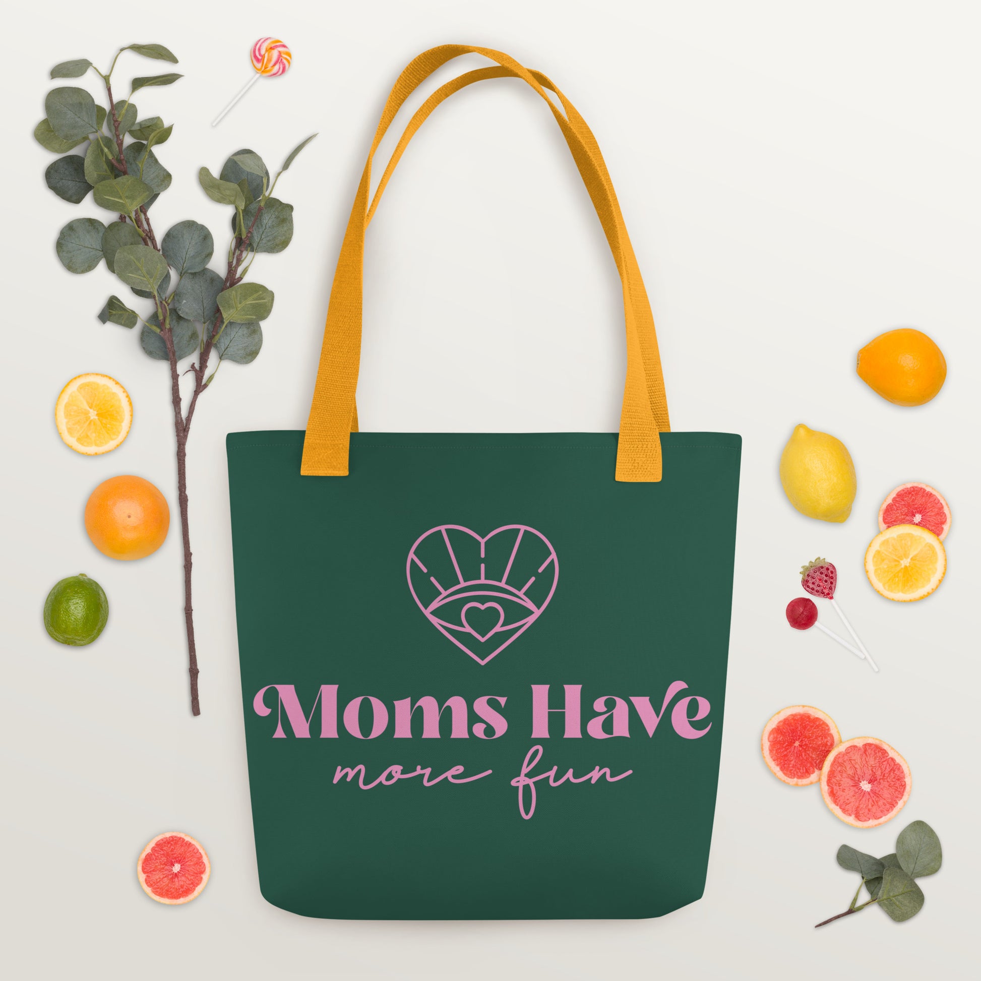 A vibrant green and pink tote with a yellow handle, showcasing the "Moms Have More Fun on the Run" design, ideal for carrying mom essentials in style.