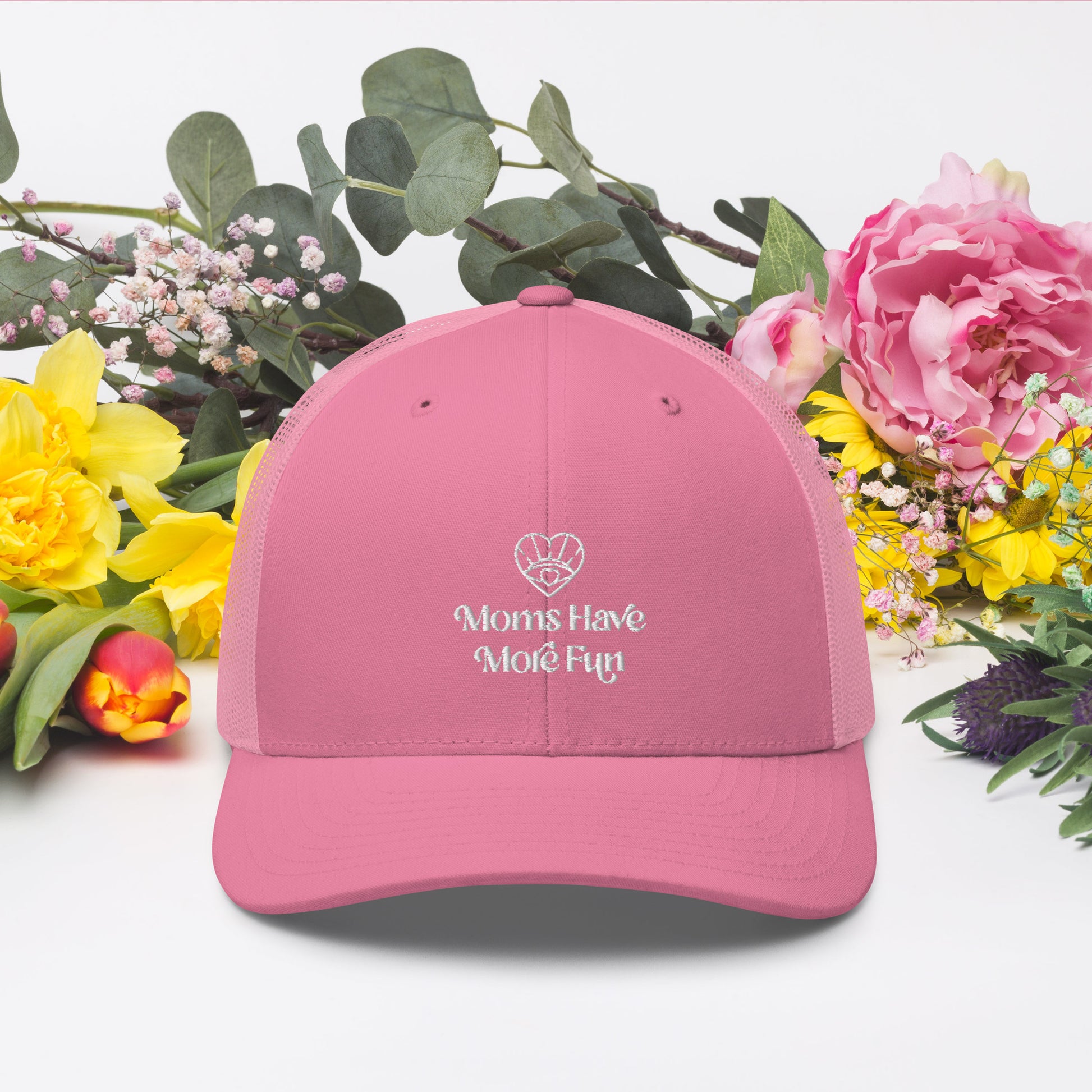 An image of the Moms Have More Fun pink trucker hat, a trendy accessory with a vibrant pink color and the brand logo embroidered on the front